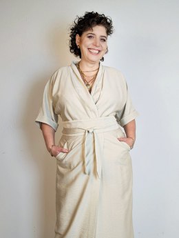 Kremowa sukienka z wąską talią, prostym dołem i kopertowym fasonem na modelu JOANNA
